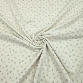 Baumwolljersey Stoff – kleine Fußspuren auf Creme
