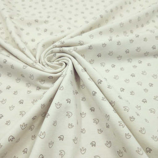 Baumwolljersey Stoff – kleine Fußspuren auf Creme