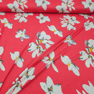 Viskosejersey Stoff – Weisse Blumen auf Korallpink