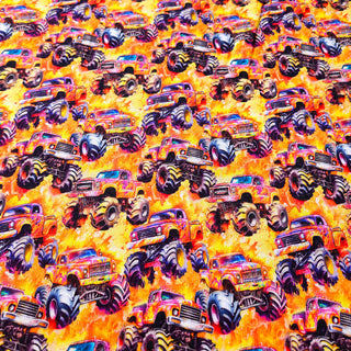 Kuschelsweat Stoff – Monster Trucks auf Orange