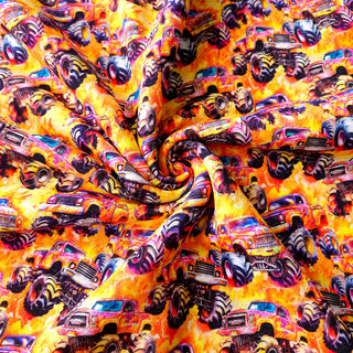 Kuschelsweat Stoff – Monster Trucks auf Orange