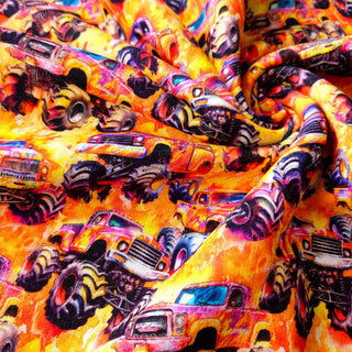 Kuschelsweat Stoff – Monster Trucks auf Orange