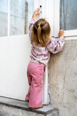 French Terry Stoff - Hübsche Einhörner auf Altrosa