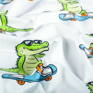 Baumwolljersey Stoff – Krokodil auf Skateboard