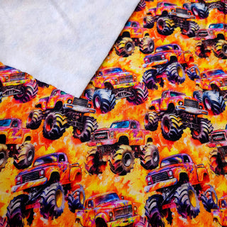 Sweat Stoff - Gelb-Orange mit Monster-Trucks