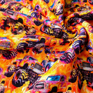 Sweat Stoff - Gelb-Orange mit Monster-Trucks