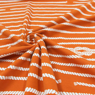 Bio Jersey Stoff orange mit weißem Seil-Muster – elastischer Baumwolljersey ideal für Kleidung und Nähprojekte – Stoffrestposten