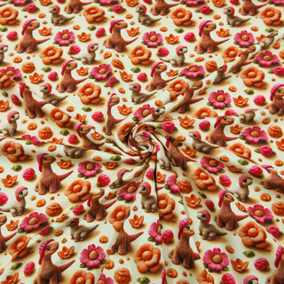Jersey Stoff 3D Digitaldruck – gestrickte Dinosaurier mit bunten Blumen in Orange, Pink und Grün, ideal für Kinderkleidung von Stoffrestposten