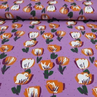 Fliederfarbener Jersey Stoff mit stilisierten Tulpen in Orange, Weiß und Grün – elastischer Baumwolljersey für Kleidung und Accessoires, verfügbar bei Stoffrestposten.