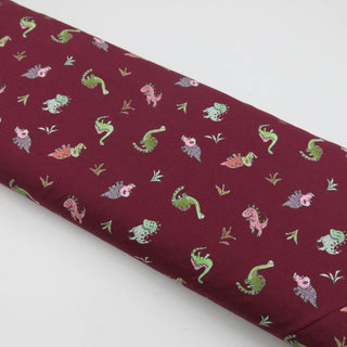 Baumwolljersey Stoff - Bordeaux mit Dinosaurier-Motiven